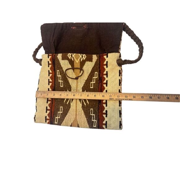 This is a bohemian-style shoulder bag with a braided strap. - Picture 7 of 8
